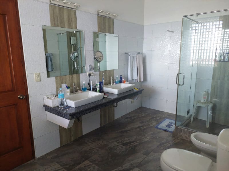 Bathroom with dual sinks and shower